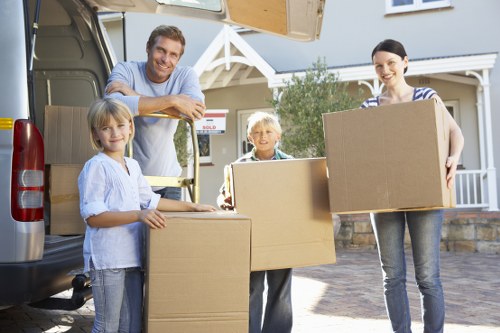 Movers carrying furniture in a Hackney Wick apartment building