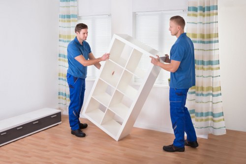 Local movers carrying furniture near Hackney Wick flats